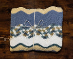 Load image into Gallery viewer, Folded crochet blanket in wavy stripes of white, beige, turquoise, light blue, and brown.
